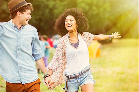 simsearch:6113-07589438,k - Happy couple in field outside tents at music festival Stock Photo - Premium Royalty-Free, Code: 6113-07564792