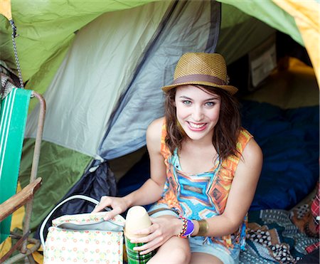 enjoy life - Portrait of smiling woman in tent at music festival Stock Photo - Premium Royalty-Free, Code: 6113-07564863