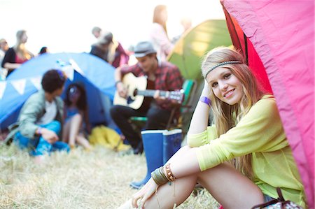 Portrait of smiling woman at tent at music festival Stock Photo - Premium Royalty-Free, Code: 6113-07564869