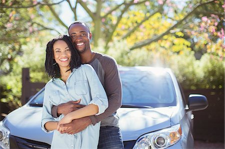 driveway - Portrait of happy couple hugging outside car Stock Photo - Premium Royalty-Free, Code: 6113-07564961