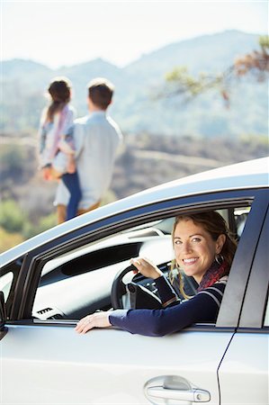 Portrait of smiling woman inside of car Stock Photo - Premium Royalty-Free, Code: 6113-07564966