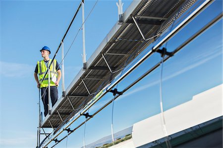 simsearch:6113-07565342,k - Worker on platform above stainless steel milk tanker Stock Photo - Premium Royalty-Free, Code: 6113-07565406