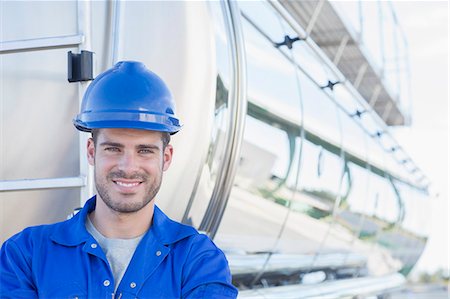 simsearch:6113-07565342,k - Portrait of smiling worker at back of stainless steel milk tanker Stock Photo - Premium Royalty-Free, Code: 6113-07565435