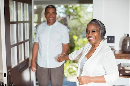 simsearch:6113-07565751,k - Portrait of smiling senior couple holding hands in doorway Stock Photo - Premium Royalty-Free, Code: 6113-07565568