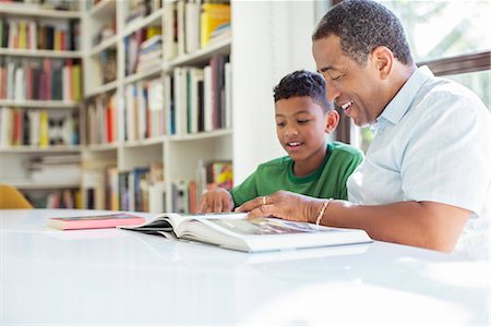 Grandfather and grandson reading book Stock Photo - Premium Royalty-Free, Code: 6113-07565539