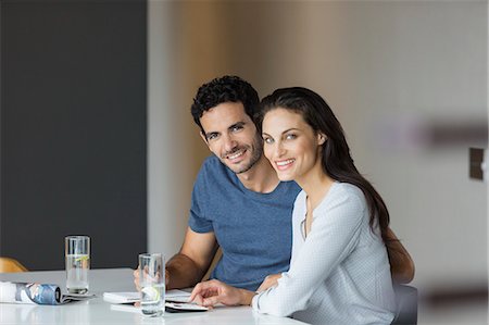 simsearch:6113-07565751,k - Portrait of smiling couple paying bills at table Stock Photo - Premium Royalty-Free, Code: 6113-07565807