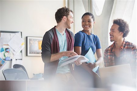 people standing casual - Casual business people discussing paperwork in meeting Stock Photo - Premium Royalty-Free, Code: 6113-07565913