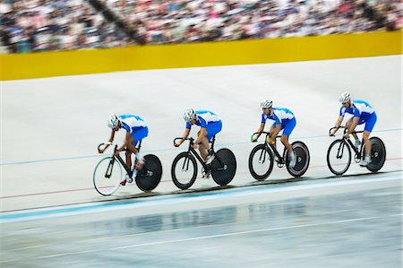 simsearch:6113-07588662,k - Track cycling team riding around velodrome Stock Photo - Premium Royalty-Free, Code: 6113-07588648