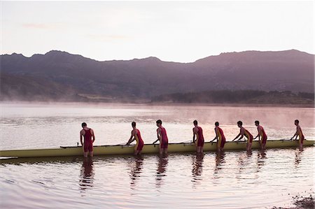 sport rowing teamwork - Rowing crew placing scull in lake at dawn Stock Photo - Premium Royalty-Free, Code: 6113-07588680