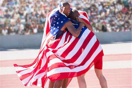 simsearch:6113-07730475,k - Track and field athletes wrapped in American flag on track Stock Photo - Premium Royalty-Free, Code: 6113-07588690