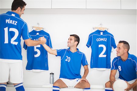 football players in lockerroom - Soccer players shaking hands in locker room Stock Photo - Premium Royalty-Free, Code: 6113-07588870