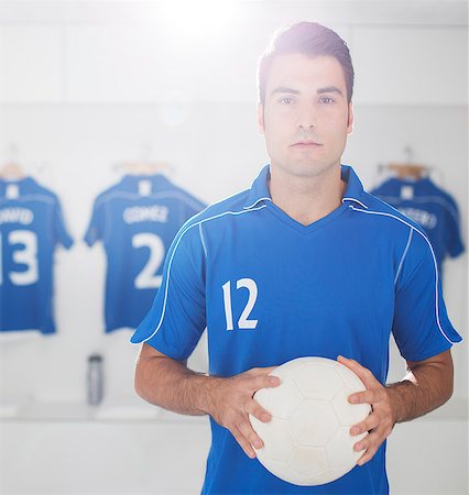 football players in lockerroom - Soccer player holding ball in locker room Stock Photo - Premium Royalty-Free, Code: 6113-07588824