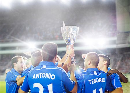 soccer - Soccer team celebrating with trophy on field Stock Photo - Premium Royalty-Free, Code: 6113-07588835