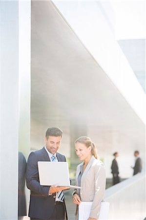 showing - Business people using laptop outdoors Photographie de stock - Premium Libres de Droits, Code: 6113-07588963