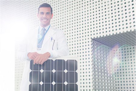environmental issues and alternative energy - Portrait of scientist with solar panel in laboratory Stock Photo - Premium Royalty-Free, Code: 6113-07589029