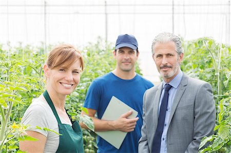 simsearch:6113-07589172,k - Portrait of confident business owner and workers in greenhouse Stock Photo - Premium Royalty-Free, Code: 6113-07589197