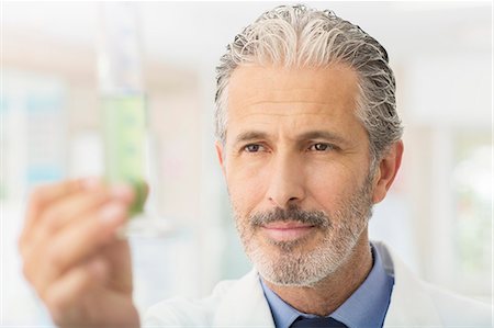 simsearch:6113-07589172,k - Scientist examining green liquid in tube Stock Photo - Premium Royalty-Free, Code: 6113-07589215