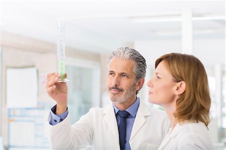 Scientists examining green liquid in tube Stock Photo - Premium Royalty-Free, Code: 6113-07589219