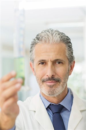 simsearch:6113-07589172,k - Portrait of confident scientist holding tube with green liquid Stock Photo - Premium Royalty-Free, Code: 6113-07589227
