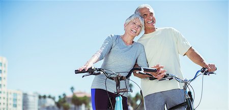 senior man bike - Senior couple with bicycles on beach Stock Photo - Premium Royalty-Free, Code: 6113-07589344