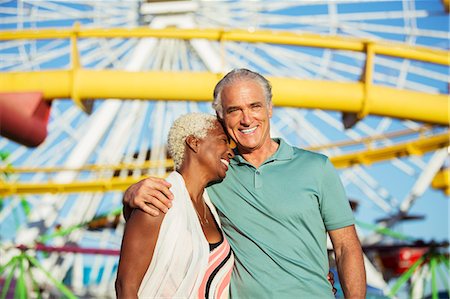 simsearch:6113-07589438,k - Portrait of hugging senior couple at amusement park Stock Photo - Premium Royalty-Free, Code: 6113-07589405