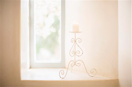 Scroll candleholder in sunny window Stock Photo - Premium Royalty-Free, Code: 6113-07589720