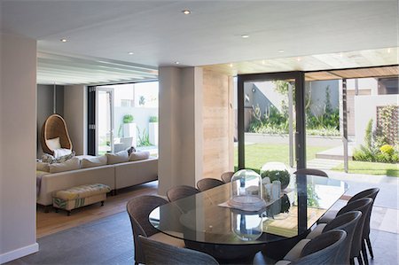 door window - Luxury dining room open to sunny patio Stock Photo - Premium Royalty-Free, Code: 6113-07589726