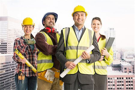 Portrait of confident construction workers in urban window Stock Photo - Premium Royalty-Free, Code: 6113-07648755