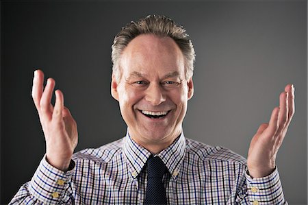 Portrait of smiling businessman gesturing Stock Photo - Premium Royalty-Free, Code: 6113-07648701