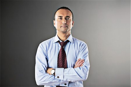 studio man photo - Portrait of confident businessman with arms crossed Stock Photo - Premium Royalty-Free, Code: 6113-07648734