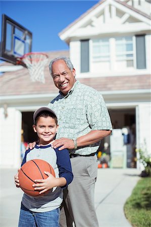 simsearch:6113-07648804,k - Portrait of smiling grandfather and grandson in sunny driveway Stock Photo - Premium Royalty-Free, Code: 6113-07648818