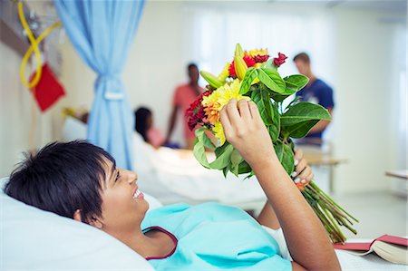 simsearch:6113-06908281,k - Patient admiring bouquet of flowers in hospital room Stock Photo - Premium Royalty-Free, Code: 6113-07762020