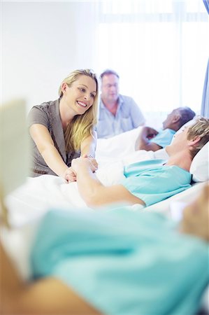 simsearch:6113-06908191,k - Woman talking to boyfriend in hospital room Stock Photo - Premium Royalty-Free, Code: 6113-07762031