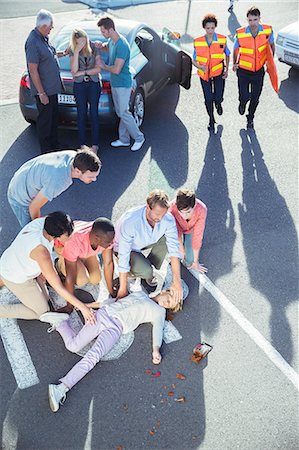 streets in motion - People examining injured girl on street Stock Photo - Premium Royalty-Free, Code: 6113-07762034