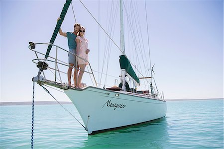 sailboat  ocean - Couple standing on front of boat Stock Photo - Premium Royalty-Free, Code: 6113-07762152