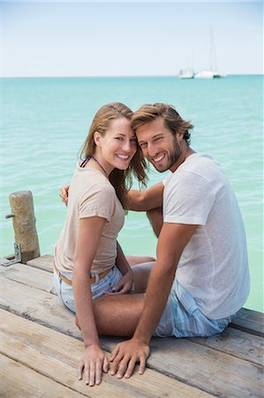 simsearch:6113-07543676,k - Couple sitting on edge of wooden dock together Stock Photo - Premium Royalty-Free, Code: 6113-07762130