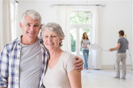 Older couple smiling together in living space Foto de stock - Sin royalties Premium, Código: 6113-07762261