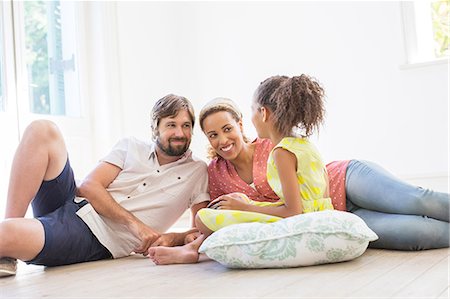 simsearch:6113-06498556,k - Family sitting on the ground in living space Stock Photo - Premium Royalty-Free, Code: 6113-07762289