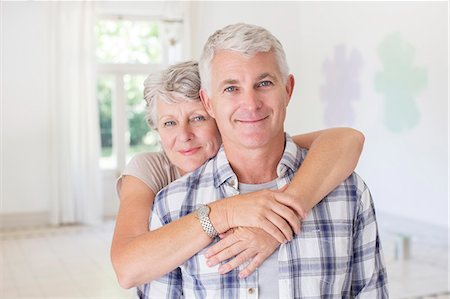 Older couple hugging in living space Stock Photo - Premium Royalty-Free, Code: 6113-07762222