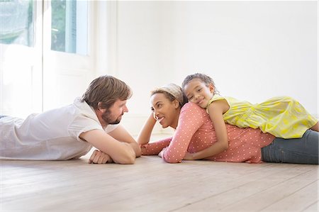 simsearch:649-03667431,k - Family laying on the ground together in living space Stock Photo - Premium Royalty-Free, Code: 6113-07762305