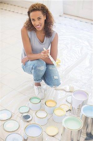 simsearch:6113-07762308,k - Woman squatting with paintbrush near paint cans Stock Photo - Premium Royalty-Free, Code: 6113-07762314