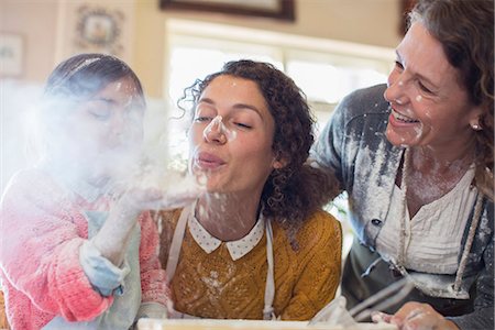 ethnic mother and daughter - Three generations of women playing with flour Stock Photo - Premium Royalty-Free, Code: 6113-07762547