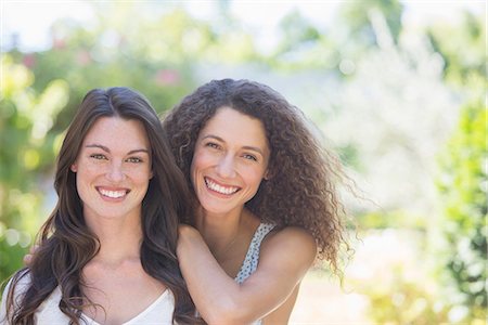 Sisters smiling together outdoors Stock Photo - Premium Royalty-Free, Code: 6113-07762590