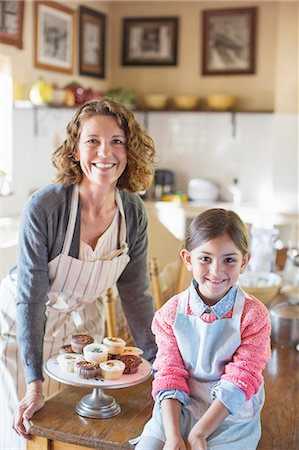 Grandmother and granddaughter smiling in kitchen Stock Photo - Premium Royalty-Free, Code: 6113-07762598