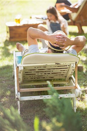 family reunion - Older man relaxing on lawn chair Stock Photo - Premium Royalty-Free, Code: 6113-07762608