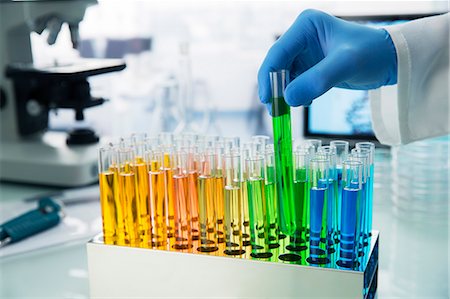 simsearch:6113-07589192,k - Scientist picking test tube out of rack on counter in lab Stock Photo - Premium Royalty-Free, Code: 6113-07790366