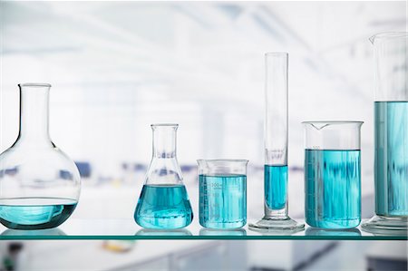 experimenting - Close up of beakers with solution on shelf in lab Stock Photo - Premium Royalty-Free, Code: 6113-07790375