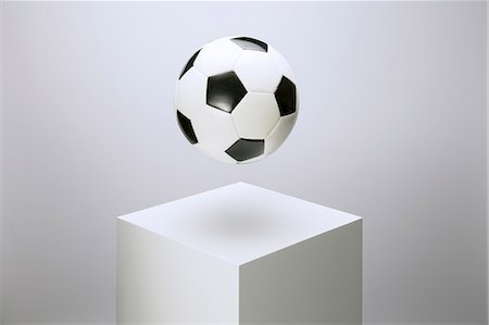 simsearch:6113-07790394,k - Soccer ball hovering over pedestal Stock Photo - Premium Royalty-Free, Code: 6113-07790387