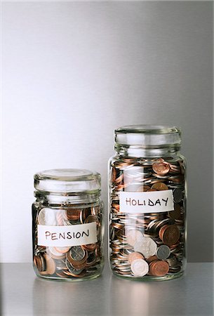 Pension and holiday change savings jars on counter Foto de stock - Sin royalties Premium, Código: 6113-07790415