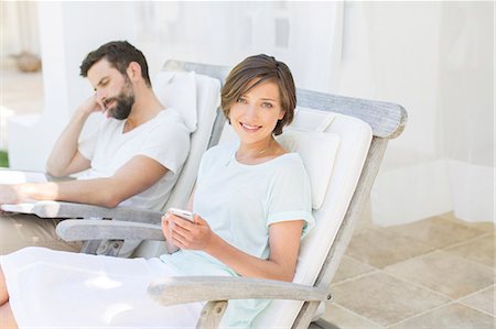 simsearch:6113-07790495,k - Couple relaxing in lawn chairs outdoors Stock Photo - Premium Royalty-Free, Code: 6113-07790540